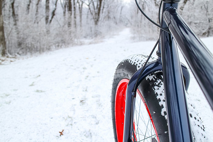 bike tire off front of bike going into snowy trail