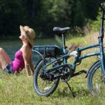 Woman enjoying electric folding bike in nature