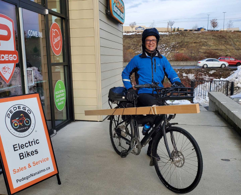 Dustin Anderson commutes to and from work on a Pedego City Commuter carrying cargo.