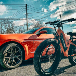 Orange car beside an orange Pedego Element ebike. Pedego eBike vs Electric Vehicle