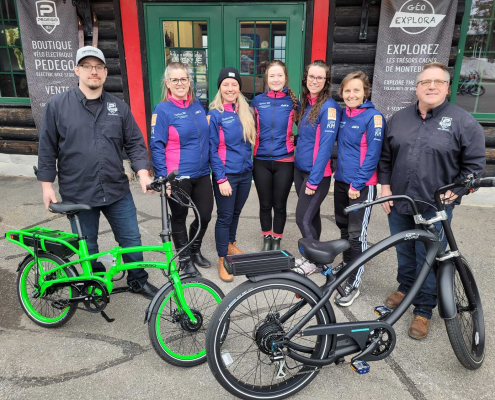 Pedego store owners with two bikes donated to a cycling team for raffle.