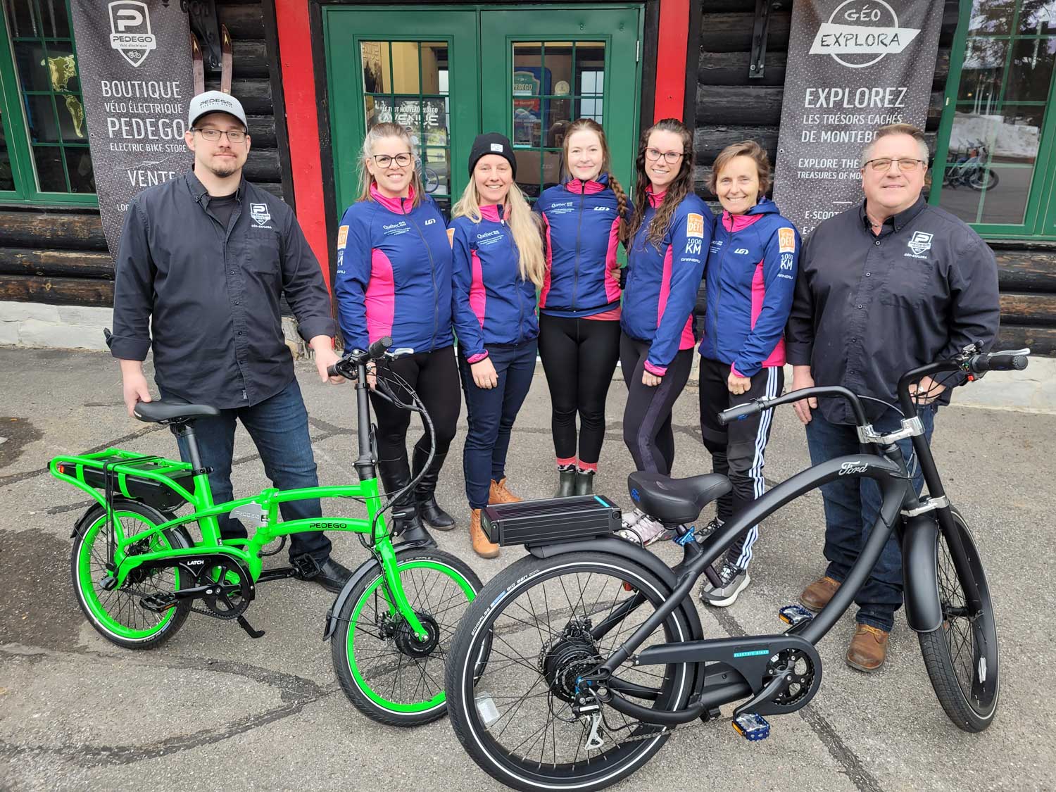 Pedego store owners with two bikes donated to a cycling team for raffle.