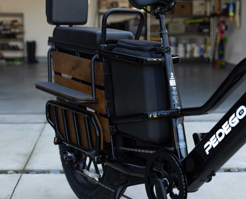 Pedego Cargo Ebike parked outside home with garage door open