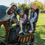 Adult loading two children on their Pedego Cargo Ebike. How to Safely Cruise with Kids on Your Pedego EBikes