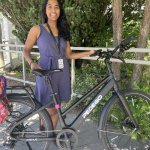 Ebike Commuter stands beside her ebike won by gobybike contest.