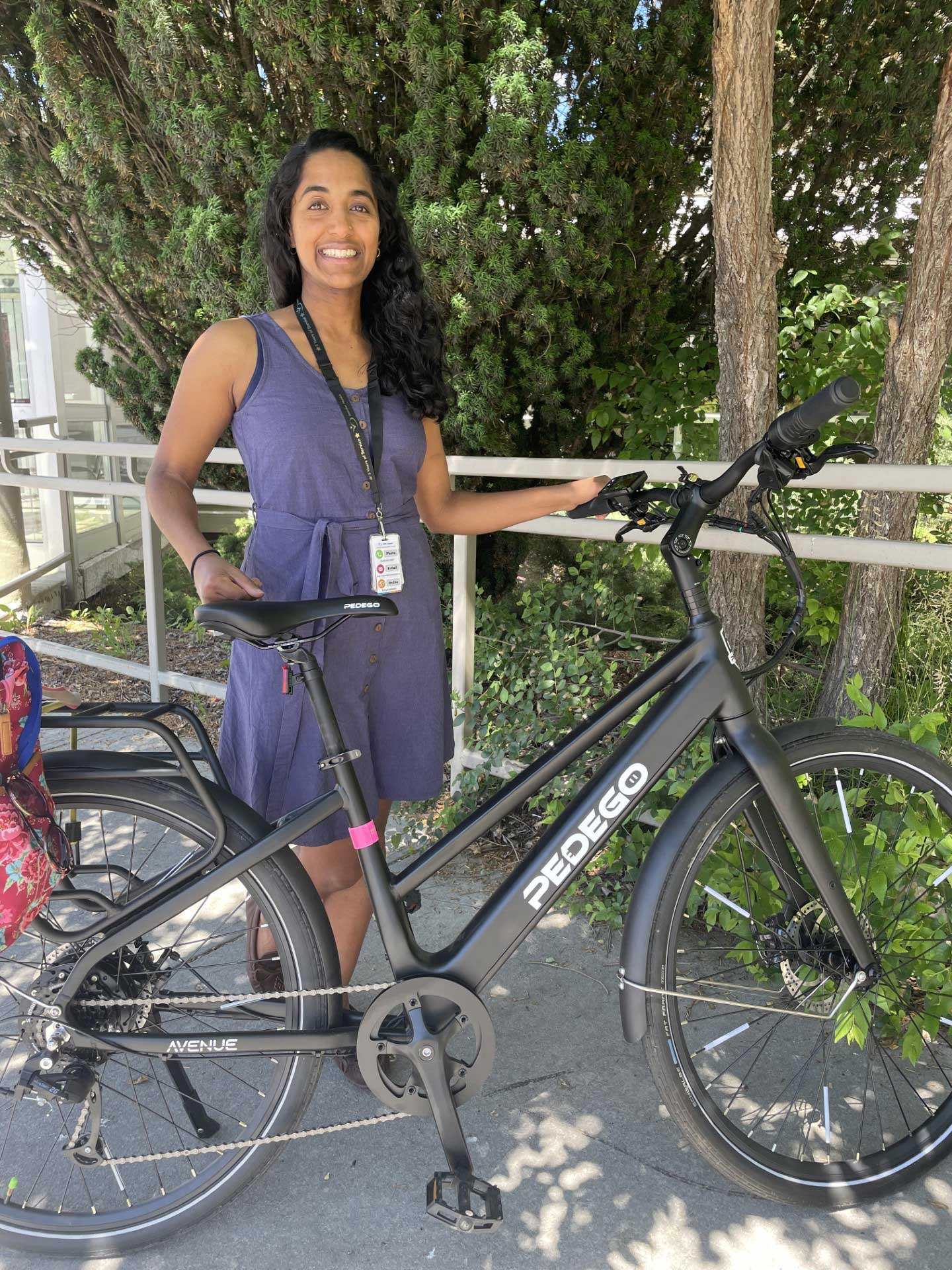 Ebike Commuter stands beside her ebike won by gobybike contest.